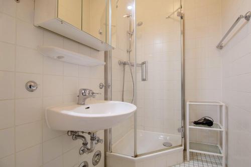 a bathroom with a sink and a shower at Villa-Strandidyll-Typ-2 in Binz