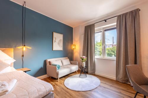 a bedroom with a bed and a chair and a window at Super zentral I Frisch renoviert in Bochum