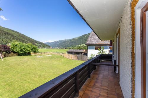 a balcony with a view of a field and mountains at Hotel Landhaus Lungau in Sankt Michael im Lungau