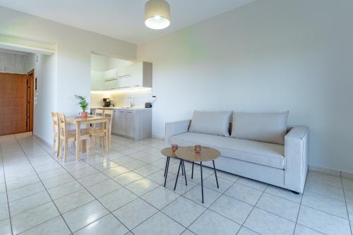 a living room with a couch and a table at Joyful Guest Houses by 8essentially in Chania Town