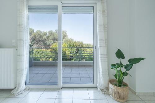an open door to a balcony with a potted plant at Joyful Guest Houses by 8essentially in Chania Town