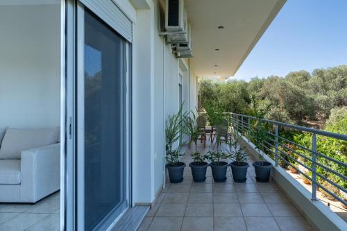 a balcony with potted plants on a house at Joyful Guest Houses by 8essentially in Chania Town