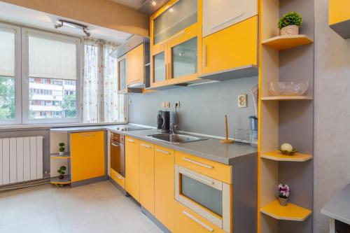 a kitchen with yellow cabinets and a sink at The Right Choice 1 in Sofia