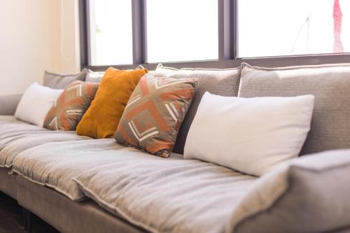 a couch with a bunch of pillows on it at Penghu Swing Sea Homestay in Magong