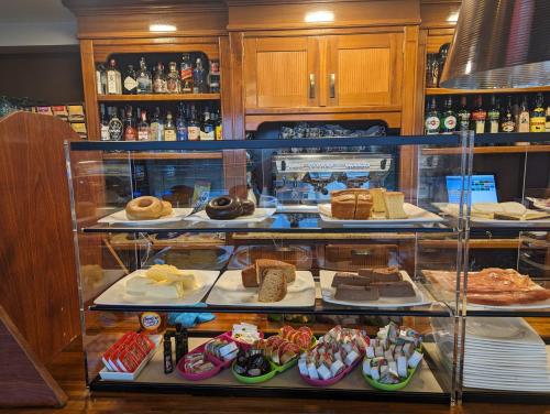 a display case filled with different types of food at La Colina in Gijón