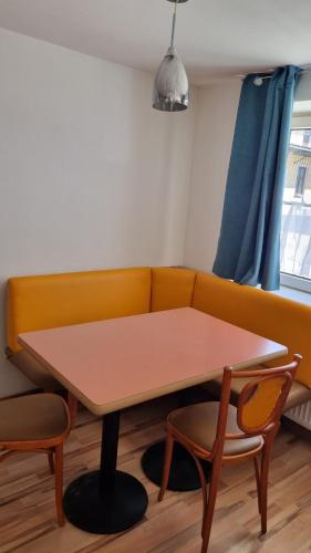 a living room with a table and a couch at Villa Theresa Apartments in Mainburg