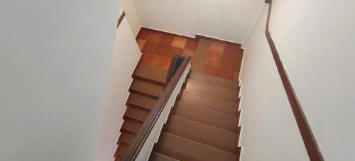 a spiral staircase in a building with wooden floors at The Boat Jetty Bungalow in Cochin