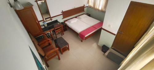 an overhead view of a bedroom with a bed and a desk at The Boat Jetty Bungalow in Cochin