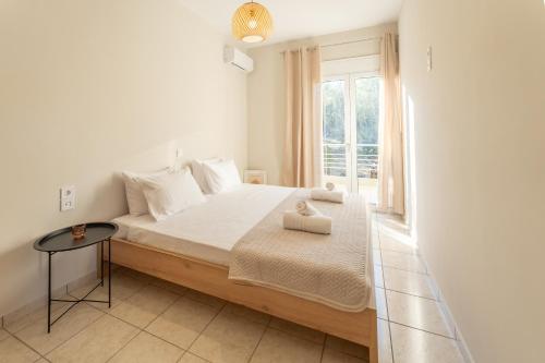 a bedroom with a large bed and a window at Joyful Guest Houses by 8essentially in Chania Town