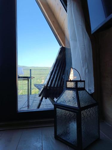 a light in front of a door with a balcony at Stone Chalets - LUNA in Jajce