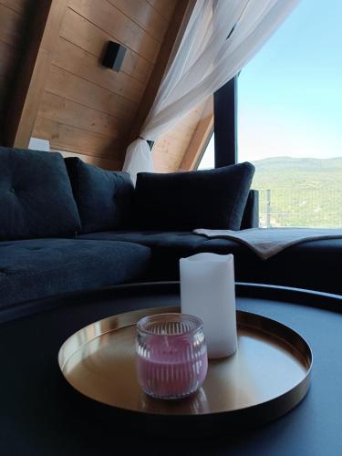 a living room with a couch and a table at Stone Chalets - LUNA in Jajce