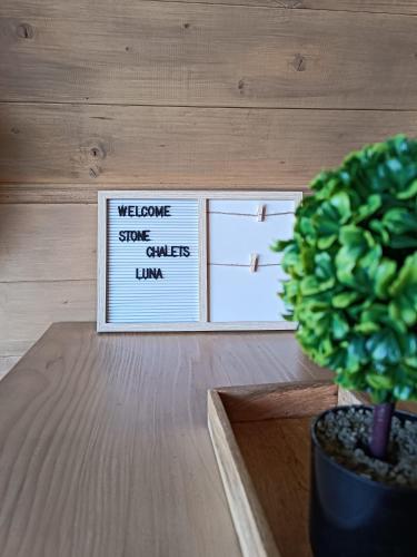 a potted plant sitting on a table next to a picture at Stone Chalets - LUNA in Jajce