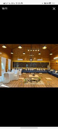 a large living room with white couches and tables at القصر الريفي in Al Khafji