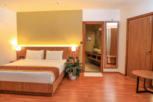 Postel nebo postele na pokoji v ubytování Hotel Sky Sierra Wayanad