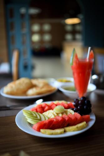 a plate of fruit and vegetables on a table at Hotel Sky Sierra Wayanad in Kalpetta