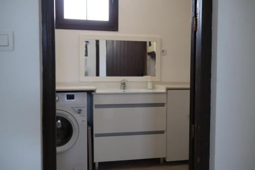 a bathroom with a sink and a washing machine at Apartment Isabel in Sorbas