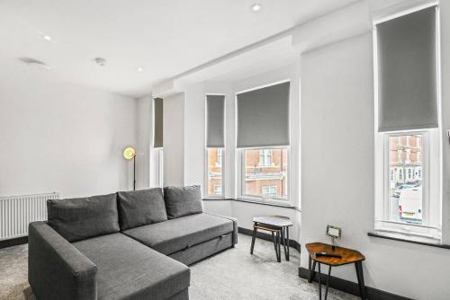 a living room with a couch and some windows at Sleek and Stylish Converted 1Bed in Old Boiler Factory - Flat 4 in Nottingham