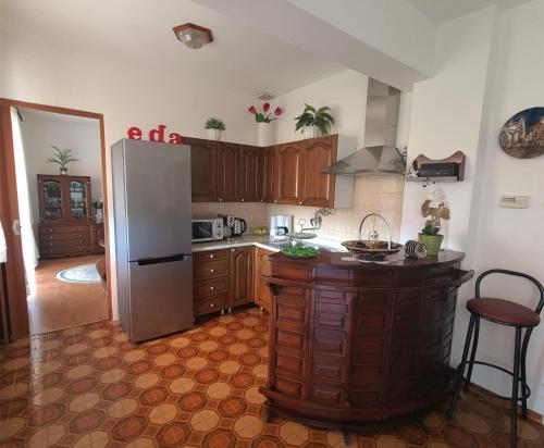 a kitchen with a refrigerator and a counter top at Apartment Eda in Labin