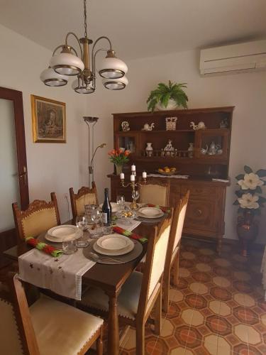 a dining room with a table with chairs and a dining room at Apartment Eda in Labin