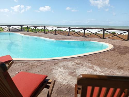 a swimming pool with a view of the ocean at HOTEL H1 MANANJARY 