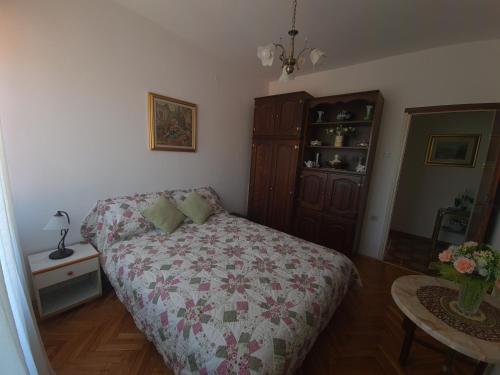 a small bedroom with a bed and a dresser at Apartment Eda in Labin