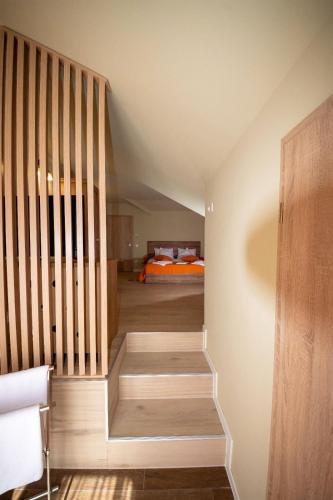 a staircase leading to a bedroom with a bed at Jagerhof in Râşnov