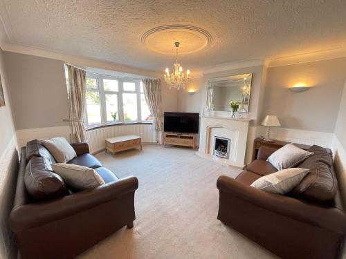 sala de estar con 2 sofás y chimenea en Seaview House, Tynemouth - Luxury Family Holiday Home, en Tynemouth