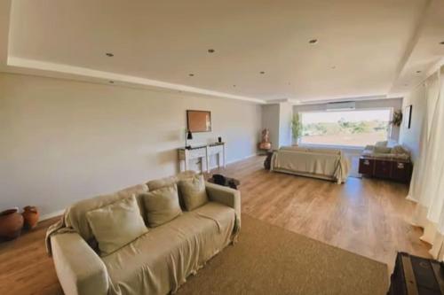 a large living room with a couch and a bed at Casa Souto da Serra in Portalegre