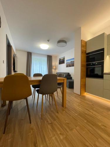 a kitchen and dining room with a table and chairs at Residence Vlčice in Pec pod Sněžkou