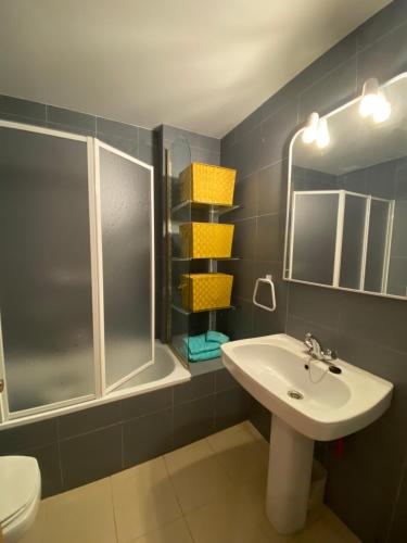 a bathroom with a sink and a shower and a toilet at Apartamento sabiñanigo in Sabiñánigo
