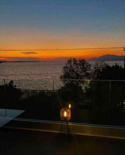 a candle sitting on top of a balcony at sunset at Apartment sea view in Chalkida