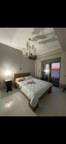 a bedroom with a large bed and a table at Apartment sea view in Chalkida