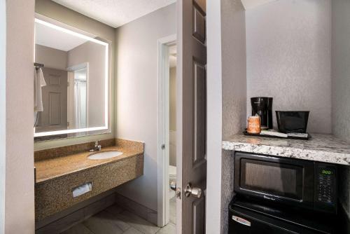 a bathroom with a sink and a microwave at Sleep Inn in Spartanburg
