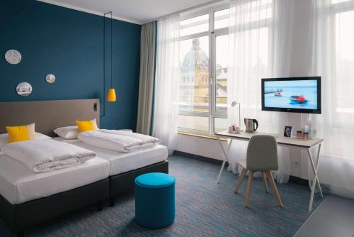 Postel nebo postele na pokoji v ubytování Vienna House Easy by Wyndham Wuppertal