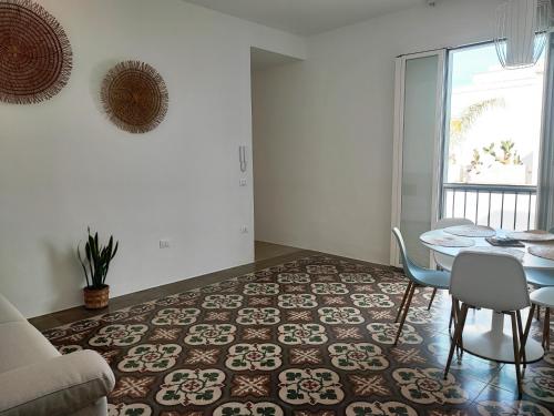 a living room with a table and chairs at La Mia Corte in Tuglie