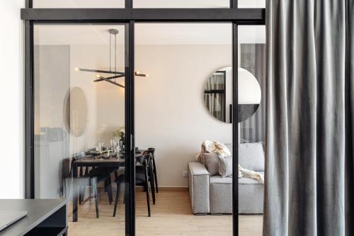 a living room with a table and a chair at Muse - LoftAffair Spa Collection in Kraków