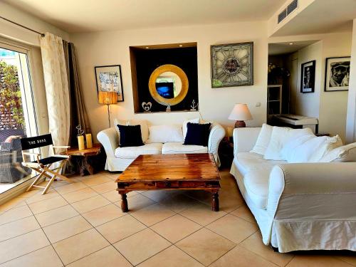 a living room with a white couch and a coffee table at Villa Les Voiles in Cannes