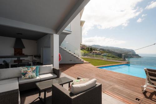 a house with a view of the ocean at Sea View Villa Mar Lindo nr Ponta do Sol in Ponta do Sol