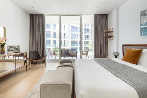 a bedroom with a large bed and a large window at Frank Porter - Al Saadiyat Island in Abu Dhabi