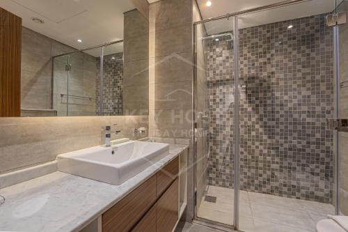 a bathroom with a sink and a shower at KeyHost - 1BR Apartment Near Five Hotel JVC - K141 in Dubai