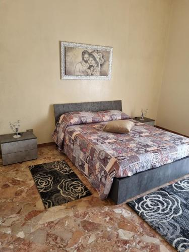 a bedroom with a bed and a picture on the wall at ANNUCCIA APARTMENT in Angri