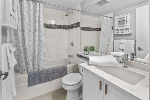 a white bathroom with a toilet and a sink at Astoria Elegance by Iris Properties in Victoria