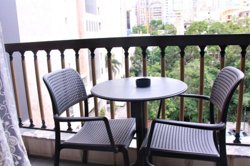 a table and two chairs sitting on a balcony at Beverly Hotel Beirut in Beirut