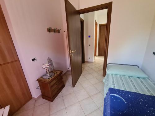 a bedroom with a bed and a room with a mirror at Casa Carpineta in Manciano