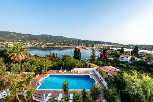an outdoor swimming pool with a view of a lake at Anamar Skiathos Hotel in Punta