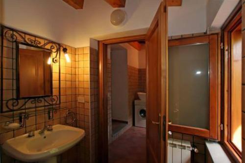 a bathroom with a sink and a mirror and a shower at Casa Rosa 1 in Patti
