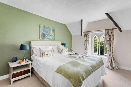 a bedroom with a large bed and a window at Gothic Cottage in Dartmouth