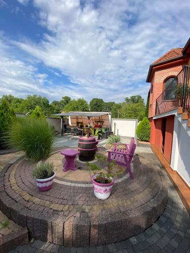 a patio with a table and a bench and plants at Sebe apartments 1 in Holíč