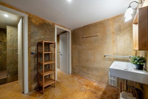 a bathroom with a sink and a shelf at Villa Lux Ana in L'Ametlla de Mar