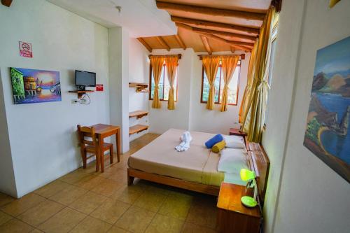 Cama o camas de una habitación en Galapagos Verde Azul